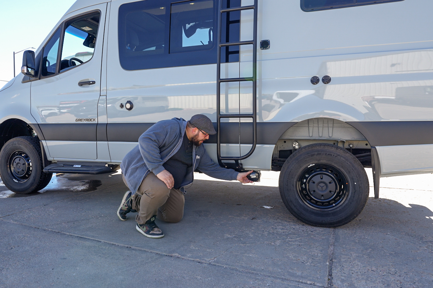 Located behind the rear tire on the driver's side is your grey water tank valve.
